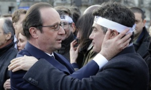 Hollande comforts Charlie Hebdo columnist Patrick Pelloux at the solidarity march. Photograph: Philippe Wojazer/AFP/Getty Images 